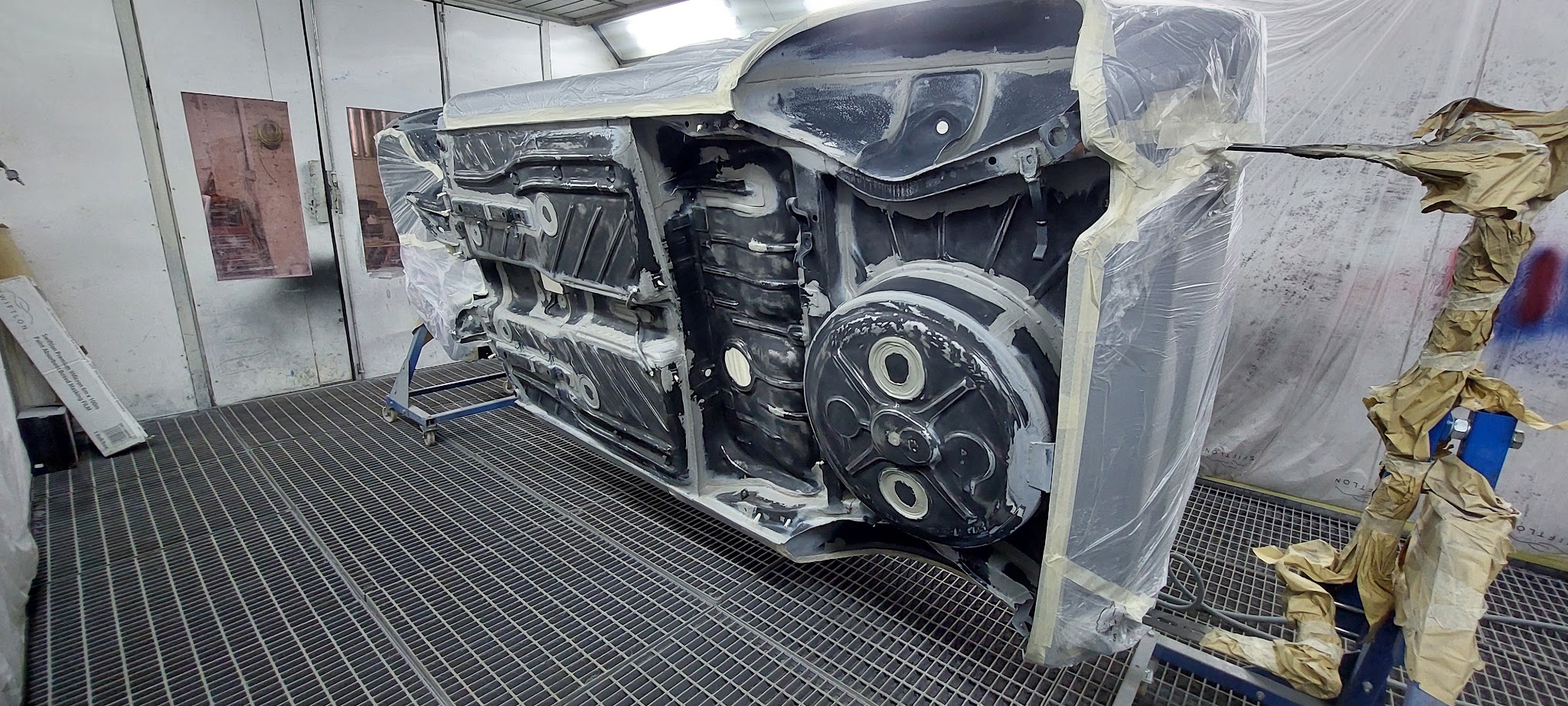 Car shell on its side with the underside exposed
