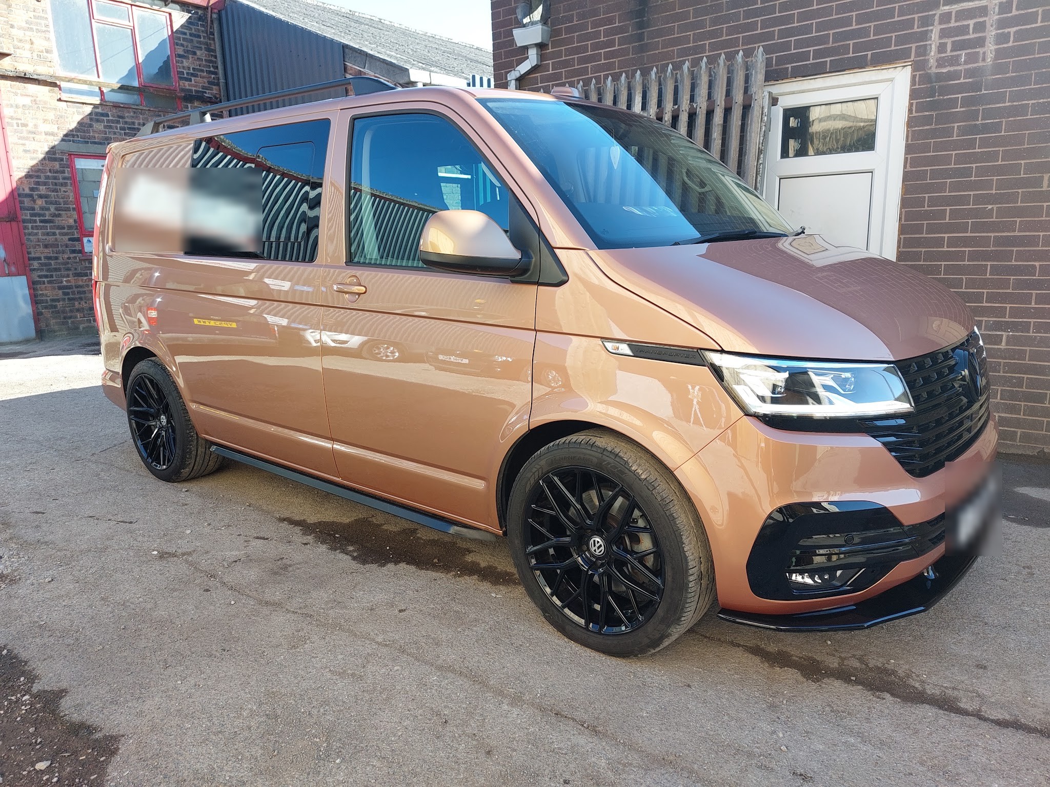 Copper VW T6 van with black wheels and trim outside the Revive Restoration workshop