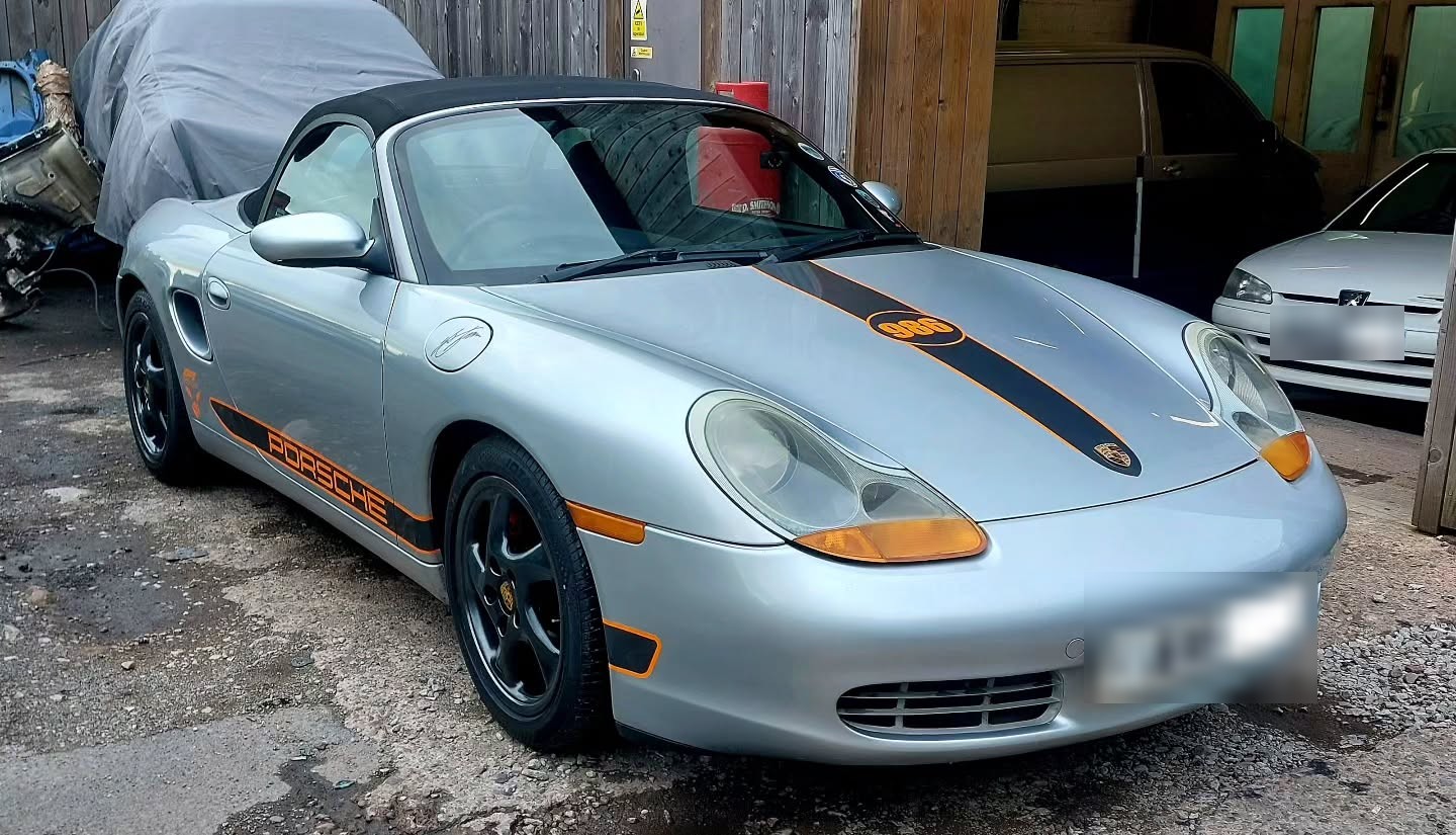 Silver Porsche Boxster S with orange and black stripes, before its colour change